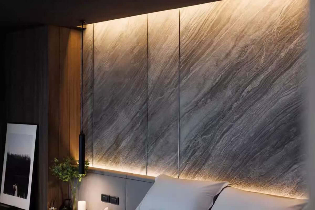 Gray marble veneer wall panels with vertical seams and warm LED accent strip