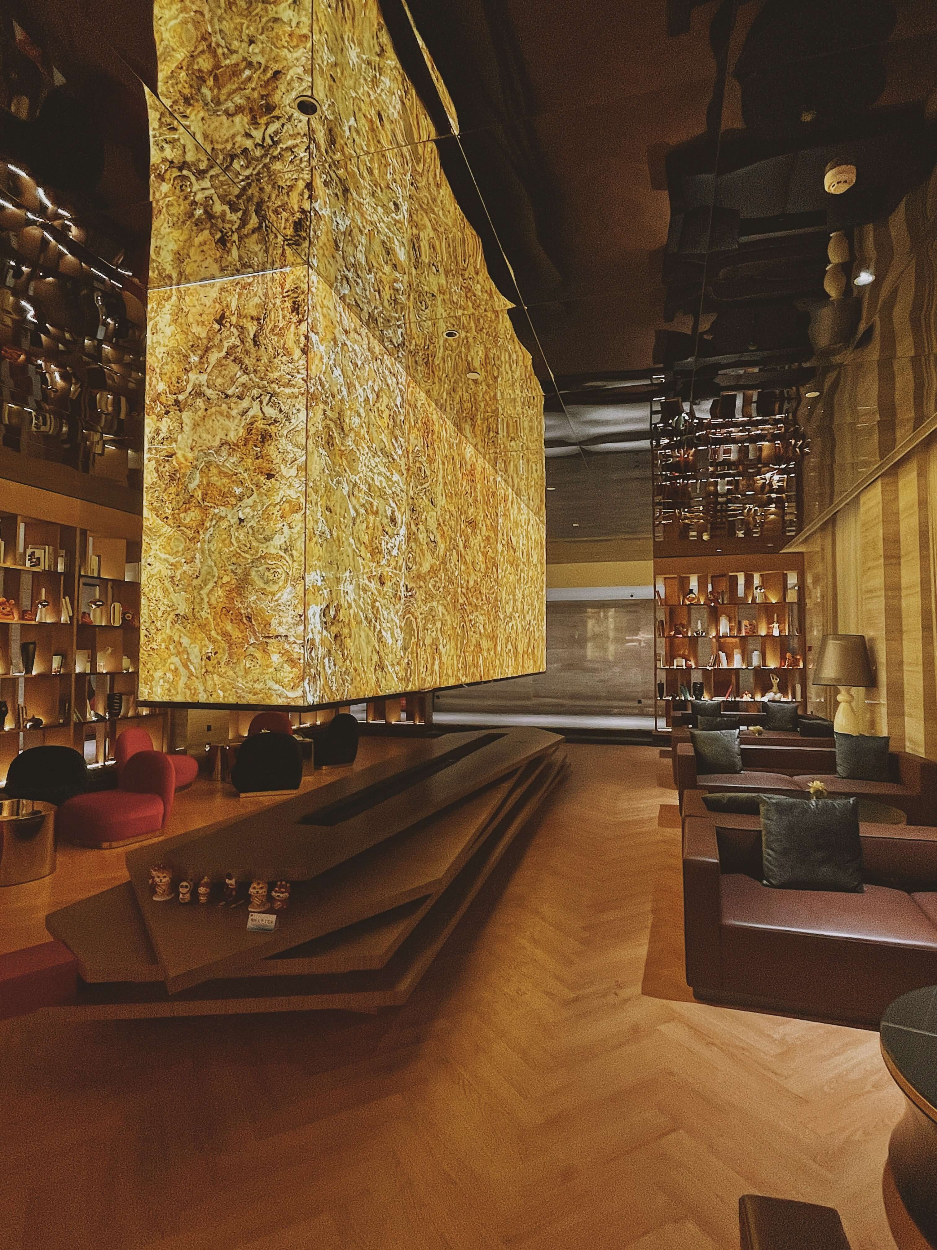 Translucent gold stone wall paneling with swirling marbled texture across large sections