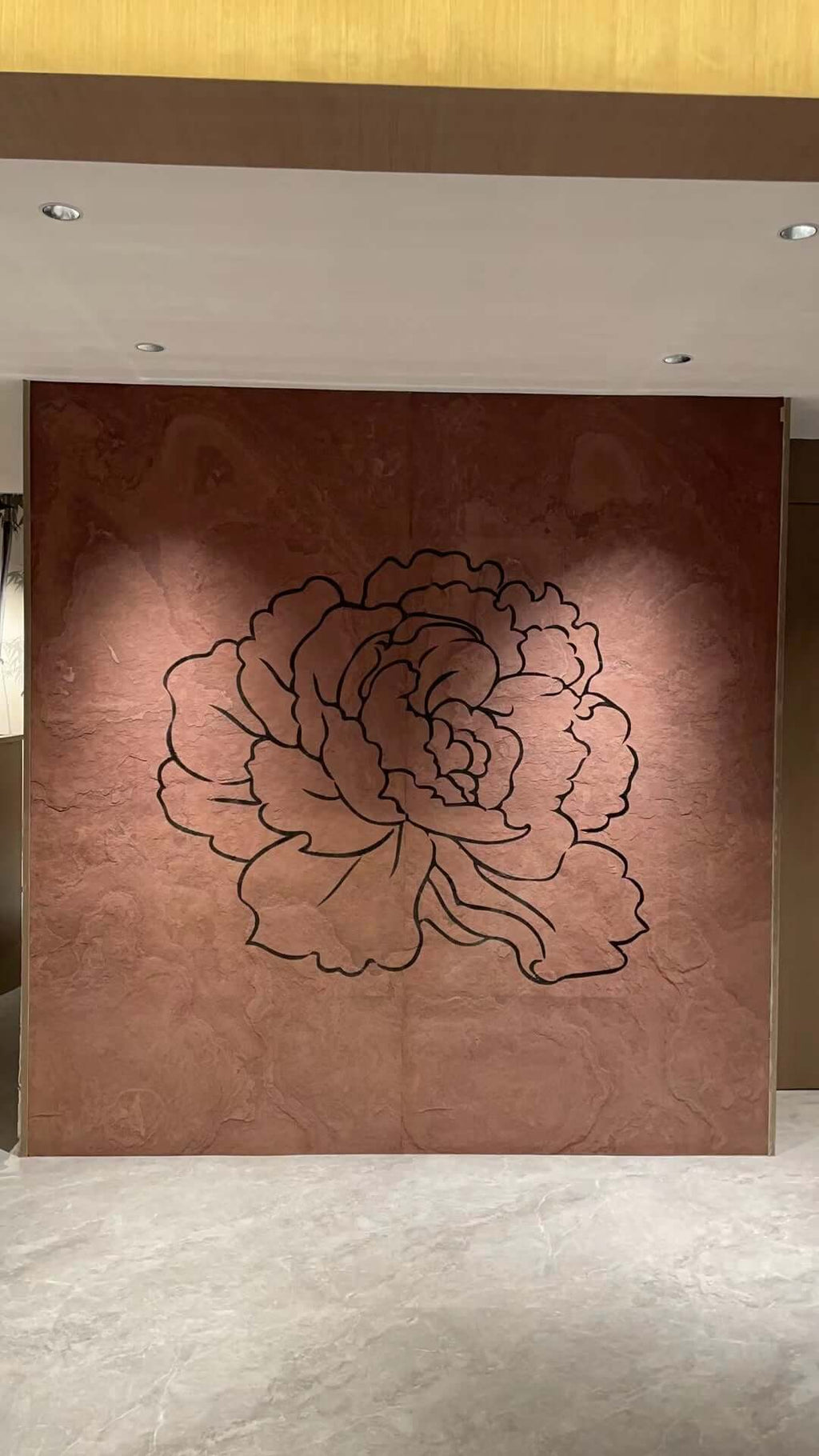 Terra red natural stone wall panel with large etched floral outline