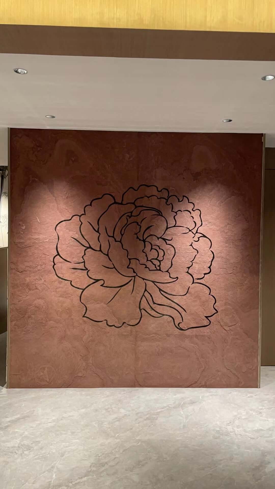 Terra red natural stone wall panel with large etched floral outline